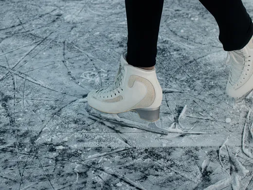 Snowy adventures on winter holidays in the Alps White ice skates on a scratched ice surface