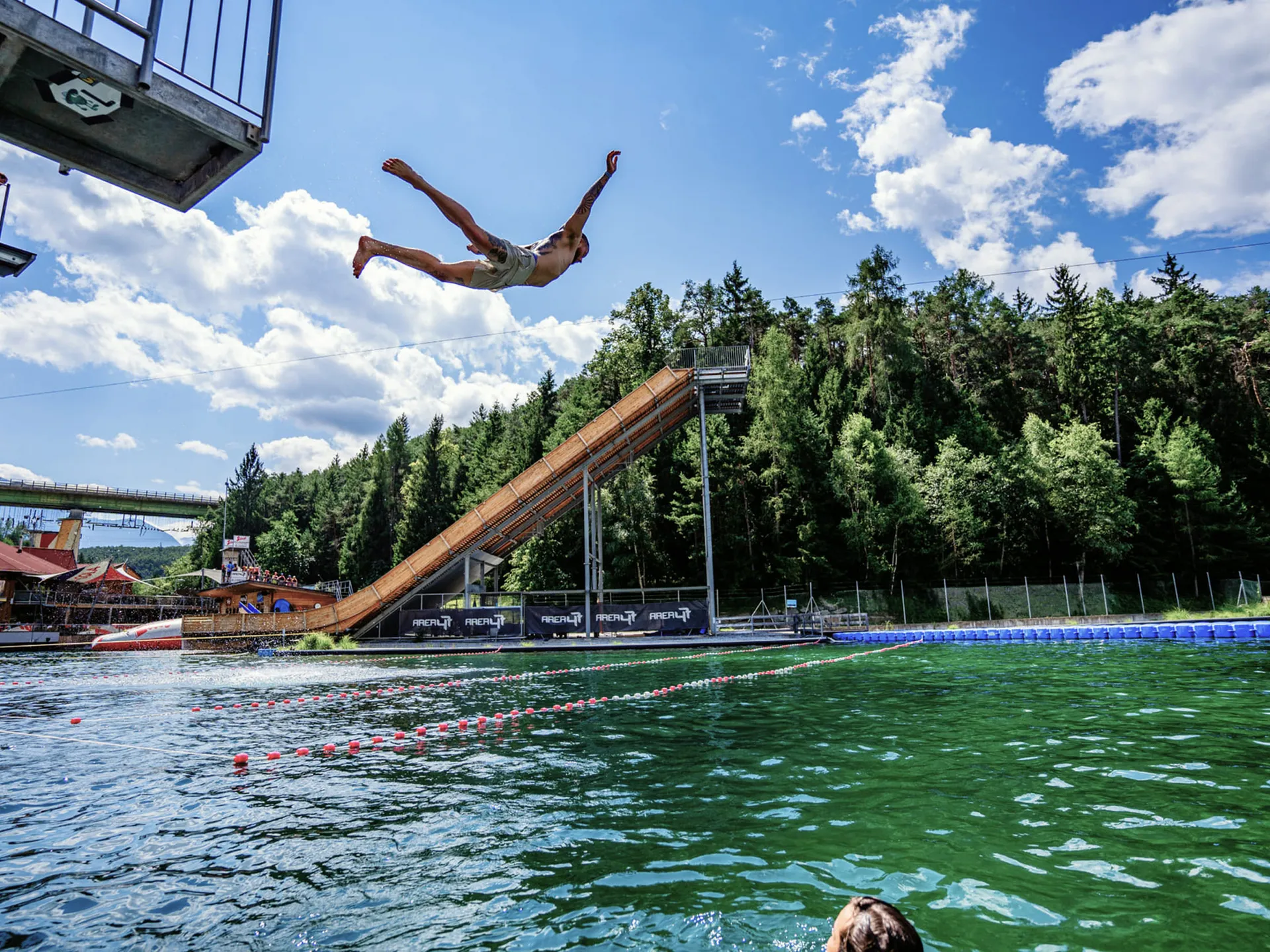 Gasthof Weisskugel: your walking holiday in the Austrian Alps Man jumps from a water slide into a large swimming pool